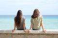 Two women contemplating ocean on the beach Royalty Free Stock Photo