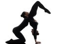 Two women contorsionist exercising gymnastic yoga silhouette Royalty Free Stock Photo