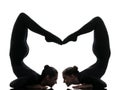 Two women contortionist exercising gymnastic yoga silhouette