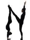 Two women contortionist exercising gymnastic yoga silhouette