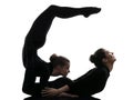 Two women contortionist exercising gymnastic yoga silhouette