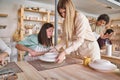 Two women creating a ceramic craft in a pottery workshop.