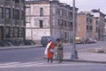 Two women crossing street in ghetto, South Bronx, New York