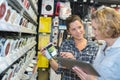 Two women in deco home painting department at hardware store