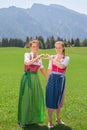 Two women in dirndl forming a heart with her hands Royalty Free Stock Photo