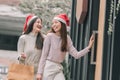 Two women doing window shopping and holding bags in christmas season Royalty Free Stock Photo