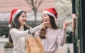 Two women doing window shopping and holding bags in christmas season Royalty Free Stock Photo