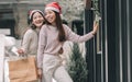 Two women doing window shopping and holding bags in christmas season Royalty Free Stock Photo