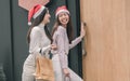 Two women doing window shopping and holding bags in christmas season Royalty Free Stock Photo