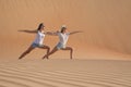Two women doing yoga in the desert. Royalty Free Stock Photo