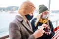 two women drinking turkish tea and salep while wearing medical mask coronavirus time Royalty Free Stock Photo