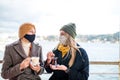 two women drinking turkish tea and salep while wearing medical mask coronavirus time Royalty Free Stock Photo