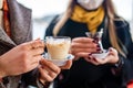 two women drinking turkish tea and salep while wearing medical mask coronavirus time Royalty Free Stock Photo