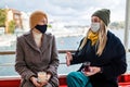 two women drinking turkish tea and salep while wearing medical mask coronavirus time Royalty Free Stock Photo