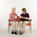 Two women drinkng coffee.