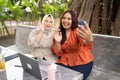 two women ended online meeting by waving at camera