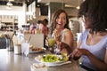 Two Women Enjoying Lunch Date In Delicatessen Restaurant