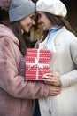 Two women exchanging a Christmas gift