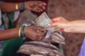 Two women exchanging money