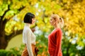 Two women are facing each other. girls looking into each others eyes. female friendship. walking in sunny park. best