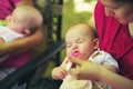 Two women feeding twins babies