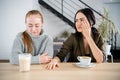 Two women friend sulking at each other, bad relationship concept