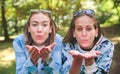 Two women friends blowing kiss to camera Royalty Free Stock Photo