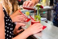 Two women friends in cafe bar drinking long drink