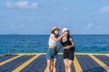 Two women friends or couples relaxing in the sea and walking at tropical beach travel summer holidays. Female tourists enjoy Royalty Free Stock Photo