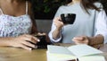 Two women friends drink coffee in cafe. Females talking and drinking latte. Royalty Free Stock Photo