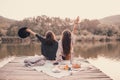 Two women friends having picnic in autumn forest near lake. Royalty Free Stock Photo