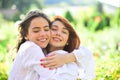 Two women friends laughing and hugging outdoors. Girls love.