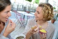 Two women friends sitting outside having lunch Royalty Free Stock Photo