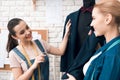 Two women at garment factory desining new man suit jacket. Royalty Free Stock Photo