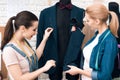 Two women at garment factory desining new man suit jacket. Royalty Free Stock Photo