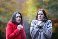 Two women getting cold in a park in autumn Royalty Free Stock Photo