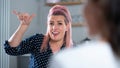 Two Women Having Conversation At Home Using Sign Language