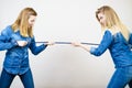 Two women having argue pulling rope