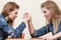 Two women having arm wrestling fight