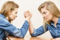 Two women having arm wrestling fight