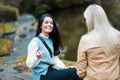 Two women having conversation in the park. Focus is on smiling woman.  Great discussion with friend Royalty Free Stock Photo