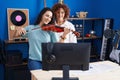 Two women having violin lesson at music studio