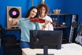 Two women having violin lesson at music studio