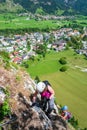 Two women high on a via ferrata route on Grancisce hill above Mojstrana village in Slovenia. Vertical