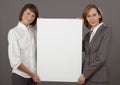 Two women holding blank board Royalty Free Stock Photo