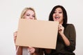 Two women holding blank board Royalty Free Stock Photo