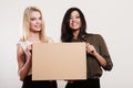 Two women holding blank board Royalty Free Stock Photo