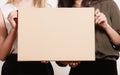Two women holding blank board Royalty Free Stock Photo