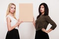 Two women holding blank board Royalty Free Stock Photo