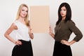 Two women holding blank board Royalty Free Stock Photo